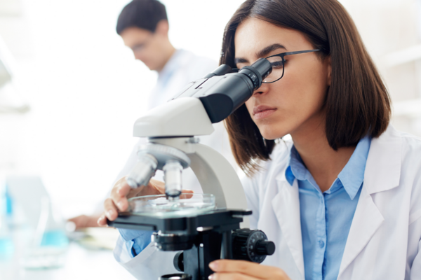 Woman scientist using a microscope