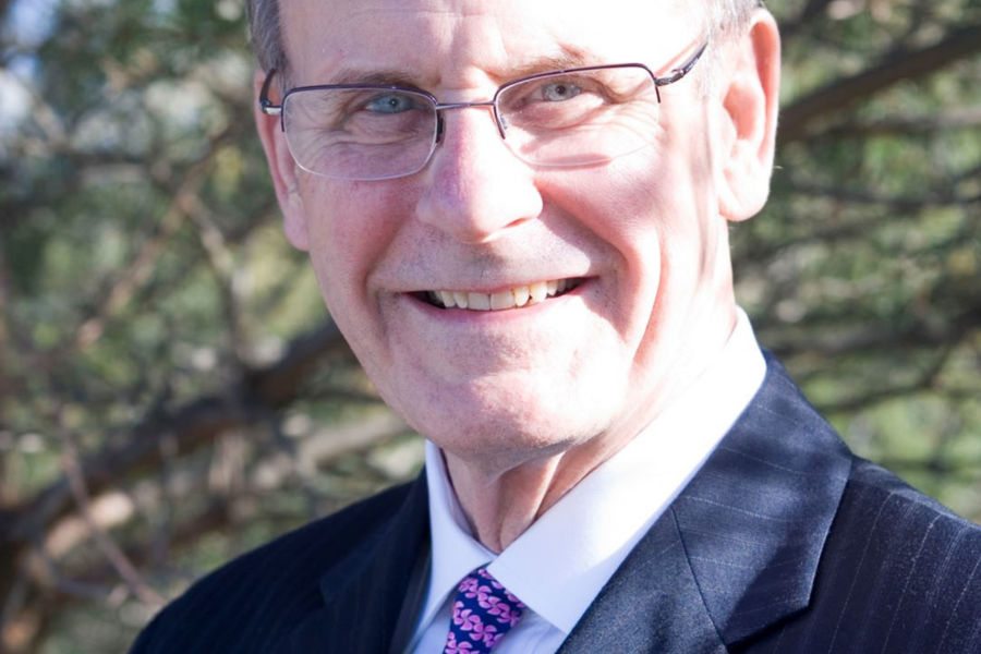 Dr. David Richard Bevan in the sunlight against a backdrop of trees