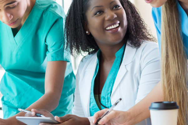 Physicians engaged in conversation while reviewing reports