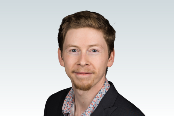Dr. Connor Brenna against a grey background