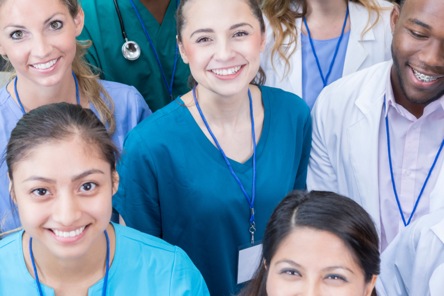 Group of medicial professionals smile at camera
