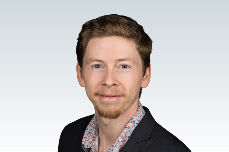Dr. Connor Brenna against a grey background