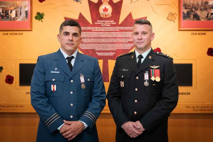 Lieutenant-Colonel Marcos Silva Restrepo and Lieutenant-Colonel Dylan Pannell in uniform against a yellow wall highlighting the Royal Canadian Legion.