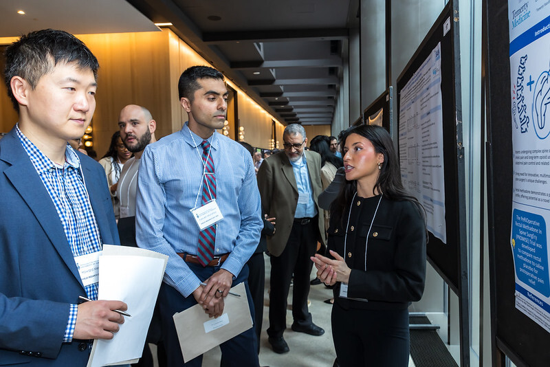 Trainees discussing a poster