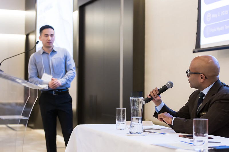 Moderator posing a question to an oral research presenter.
