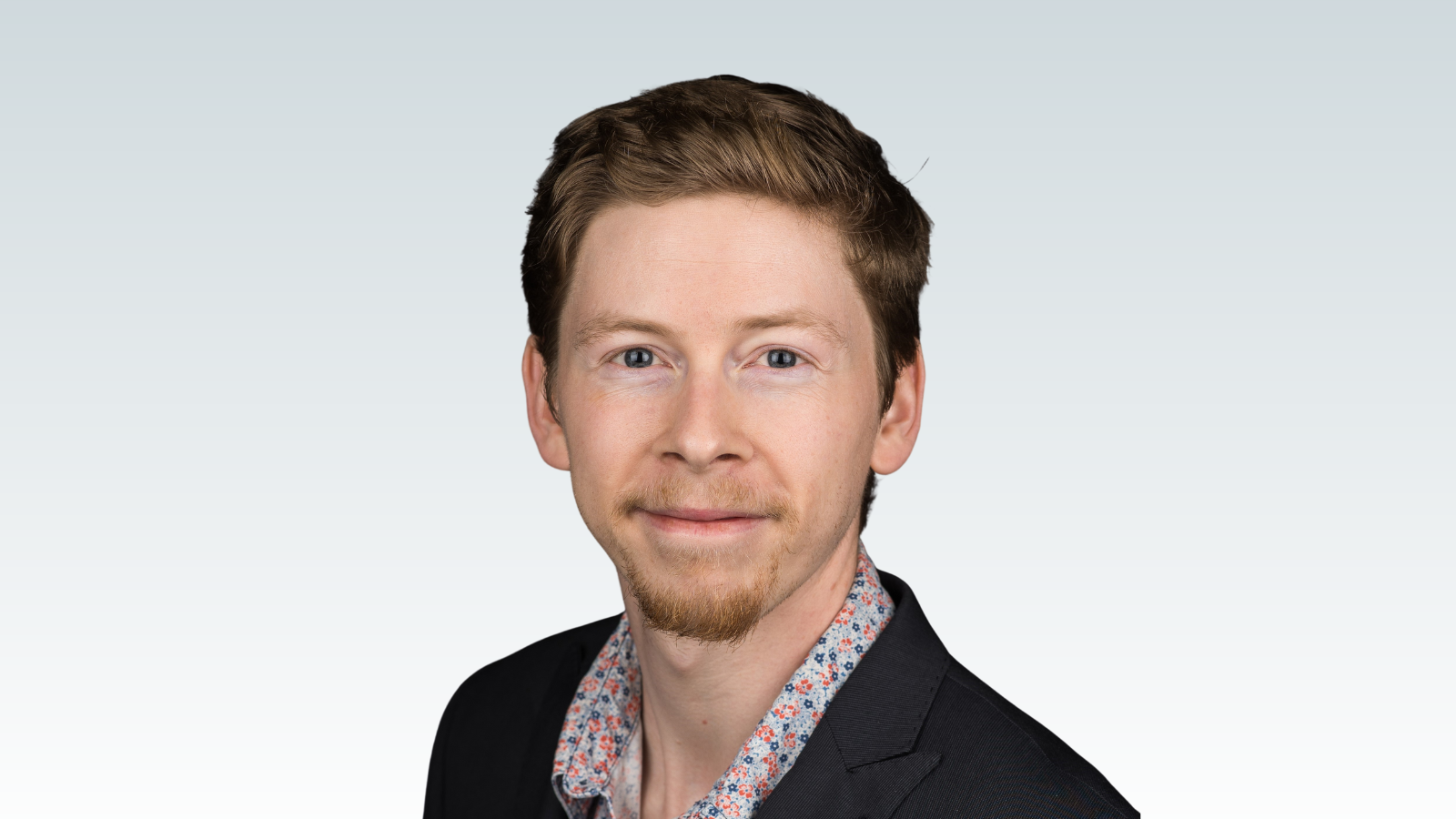 Dr. Connor Brenna against a grey background